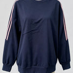 A navy blue crewneck sweatshirt with pink and white double stripes down the sleeves, displayed on a mannequin against a light gray background.
